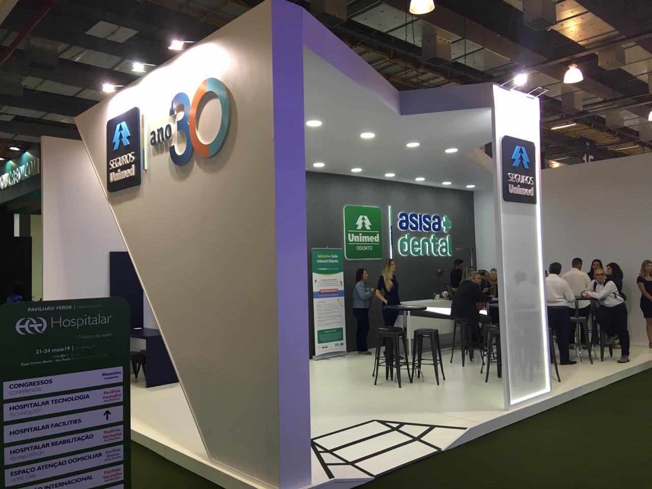 Imagem do stand da hospitalar 2019 com logos da Seguros Unimed, Unimed Odonto e 30 anos.